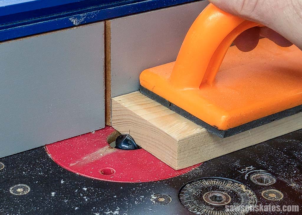 Using a router table and cove bit to make a groove in a board