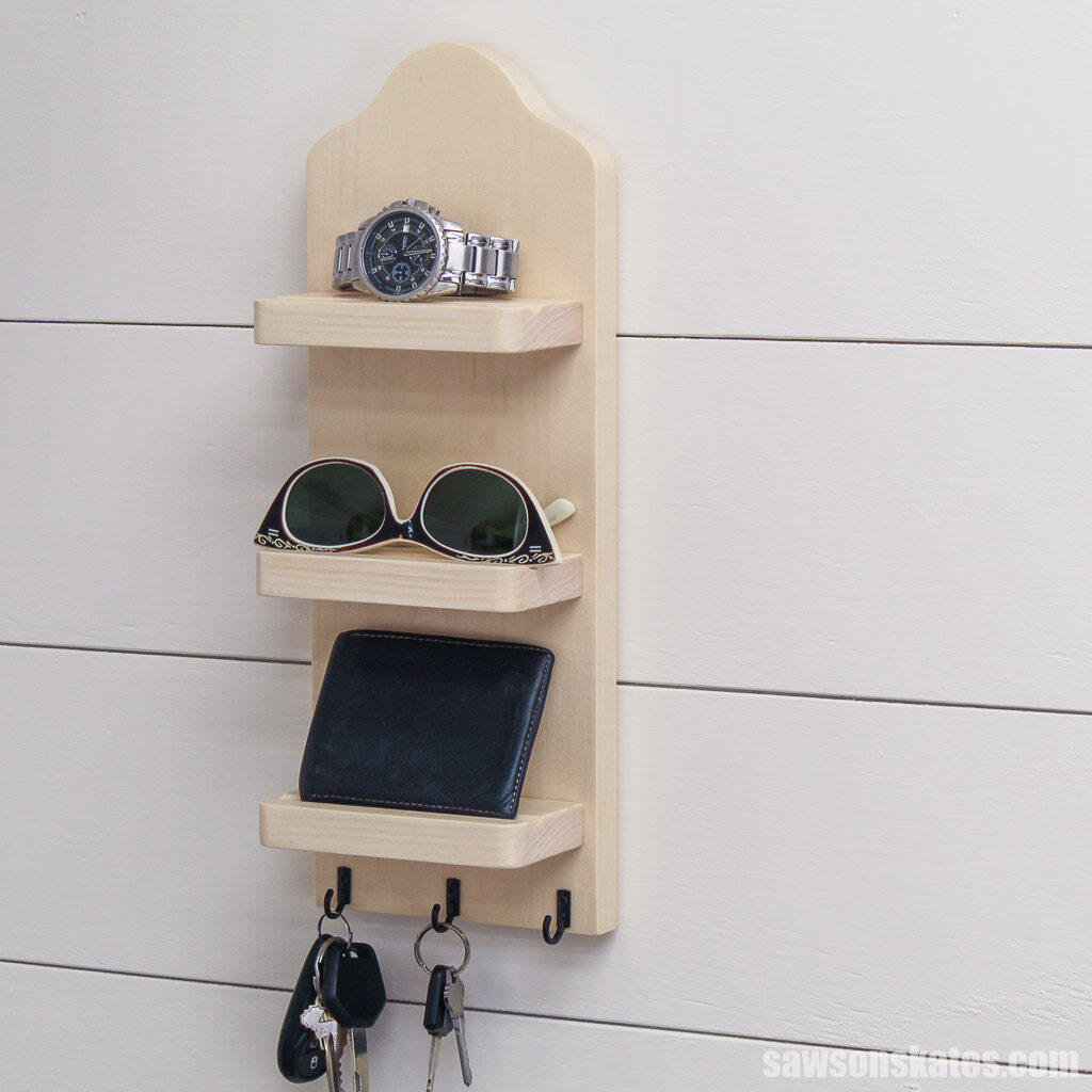 DIY key holder with three shelves on a shiplap wall