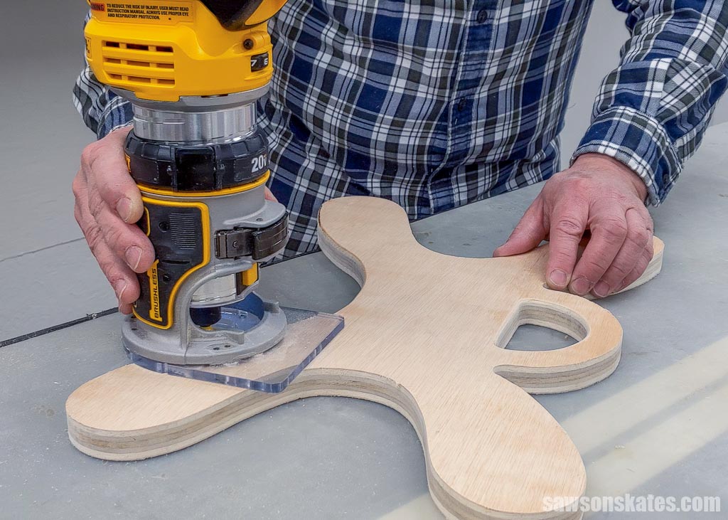 Using a handheld router to smooth a DIY extension cord holder's edges