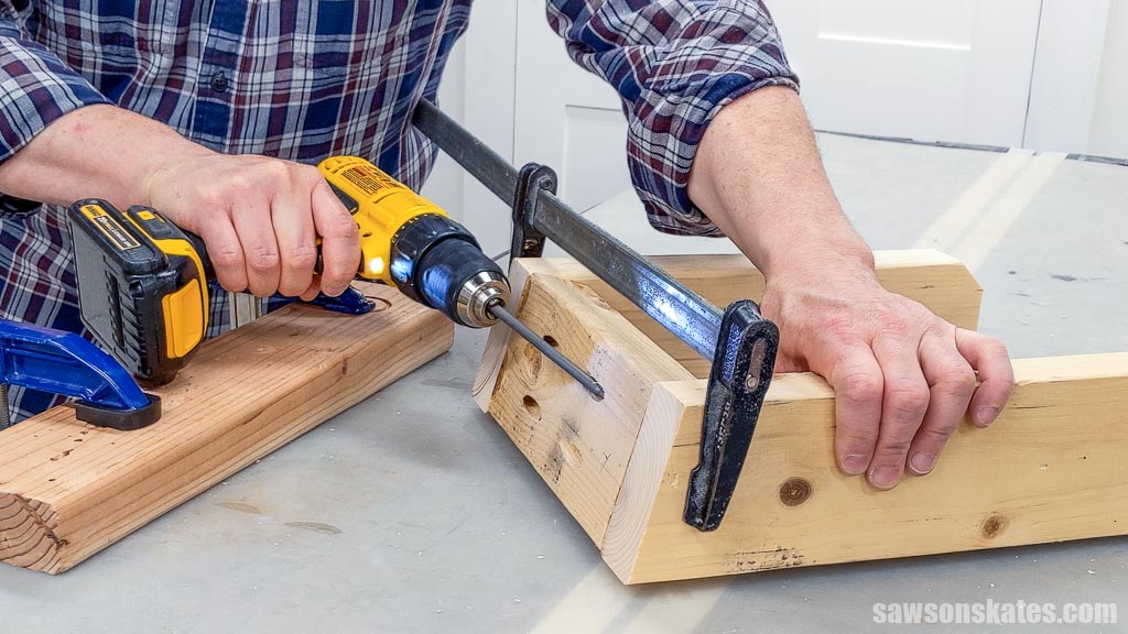 Using a drill to drive screws to assemble  DIY ladder storage hooks