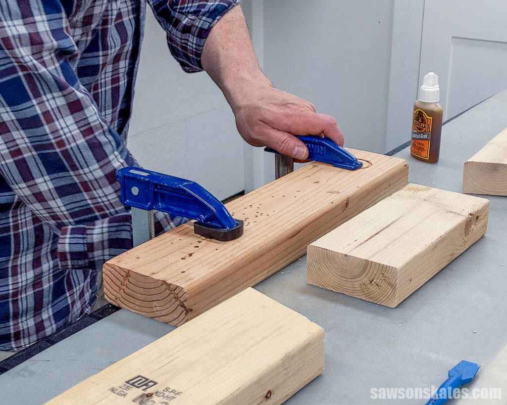 Attaching a scrap piece of wood to a workbench with a clamp