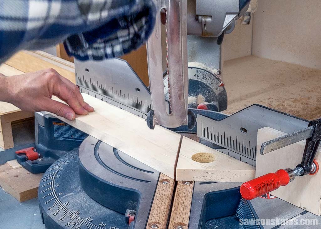 Using a miter saw to cut the second angle on the other side of a birdhouse's gable