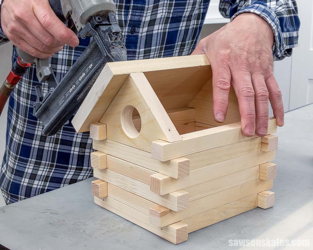 Attaching the small roof section using a brad nailer