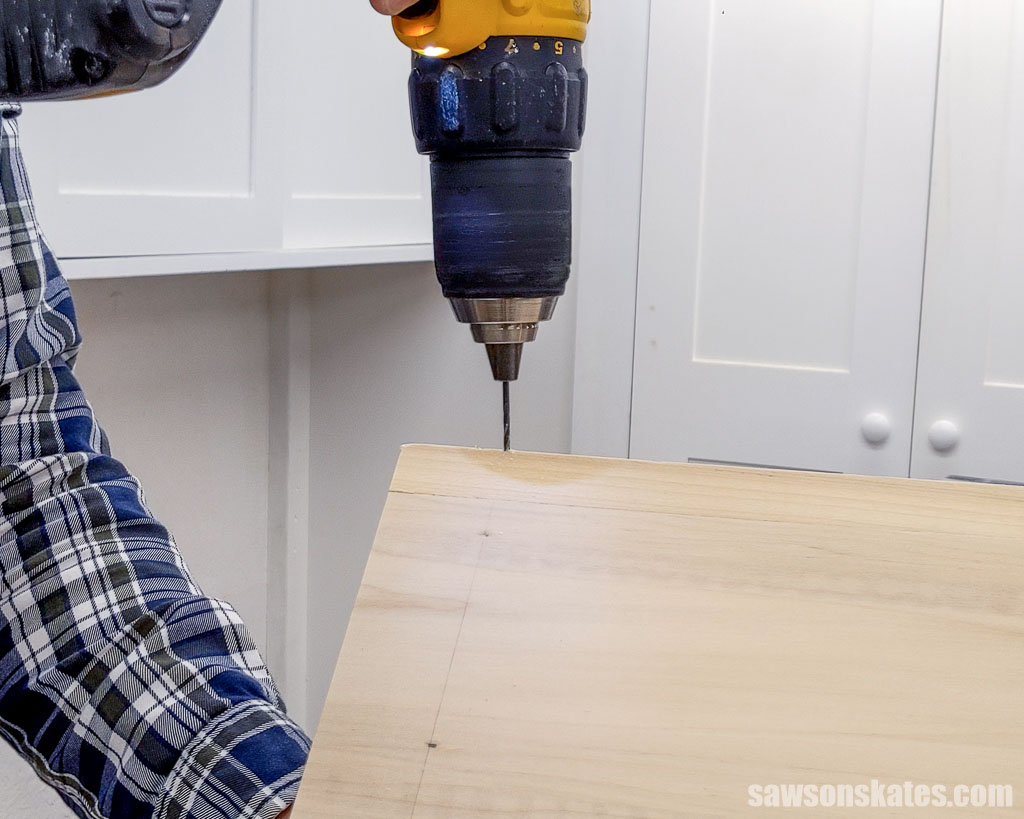 Making a pilot hole in the roof using a drill