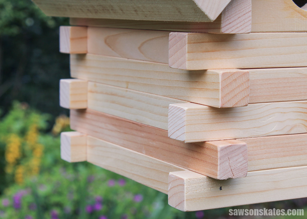 Closeup of a DIY log cabin birdhouse's walls