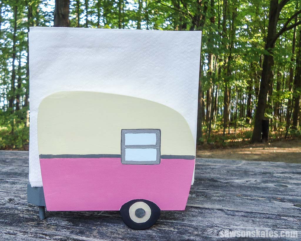 Backside of a pink DIY vintage camper napkin holder filled with white napkins