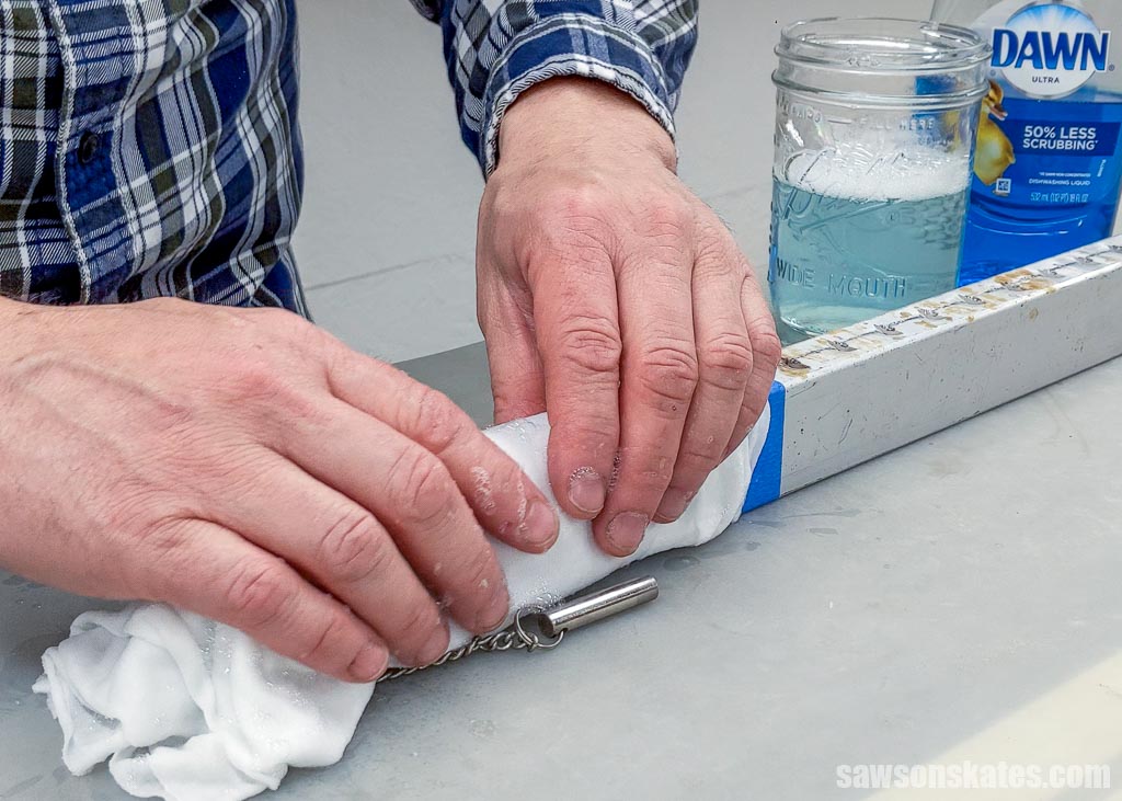 Using hot water and dish soap to remove wood glue off of a bar clamp