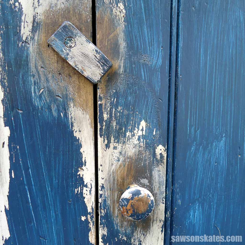 Closeup of a vintage-style DIY jelly cabinet's latch and door knob