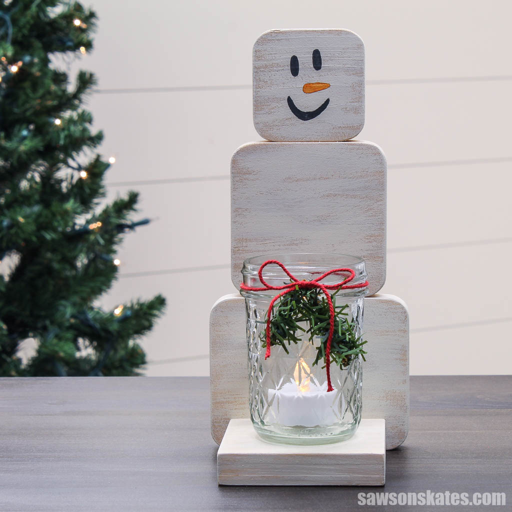 Front view of a DIY wooden snowman candle holder