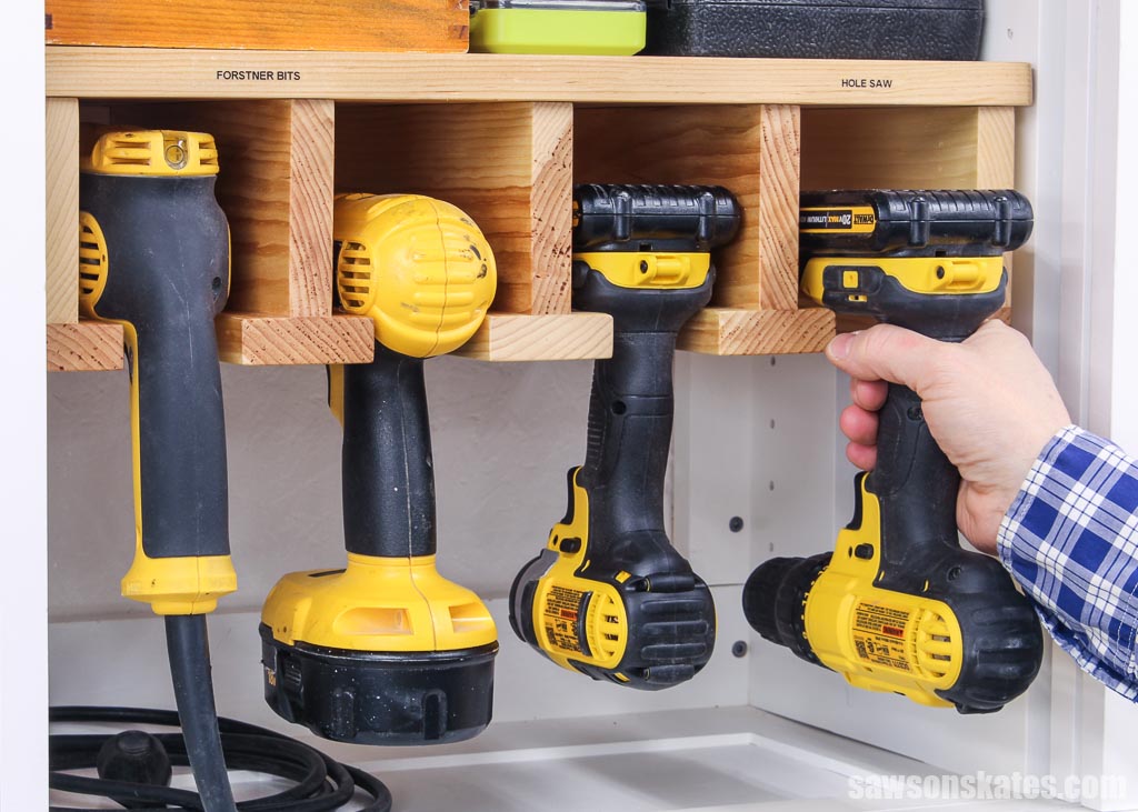 Hand placing drill into an easy DIY drill holder