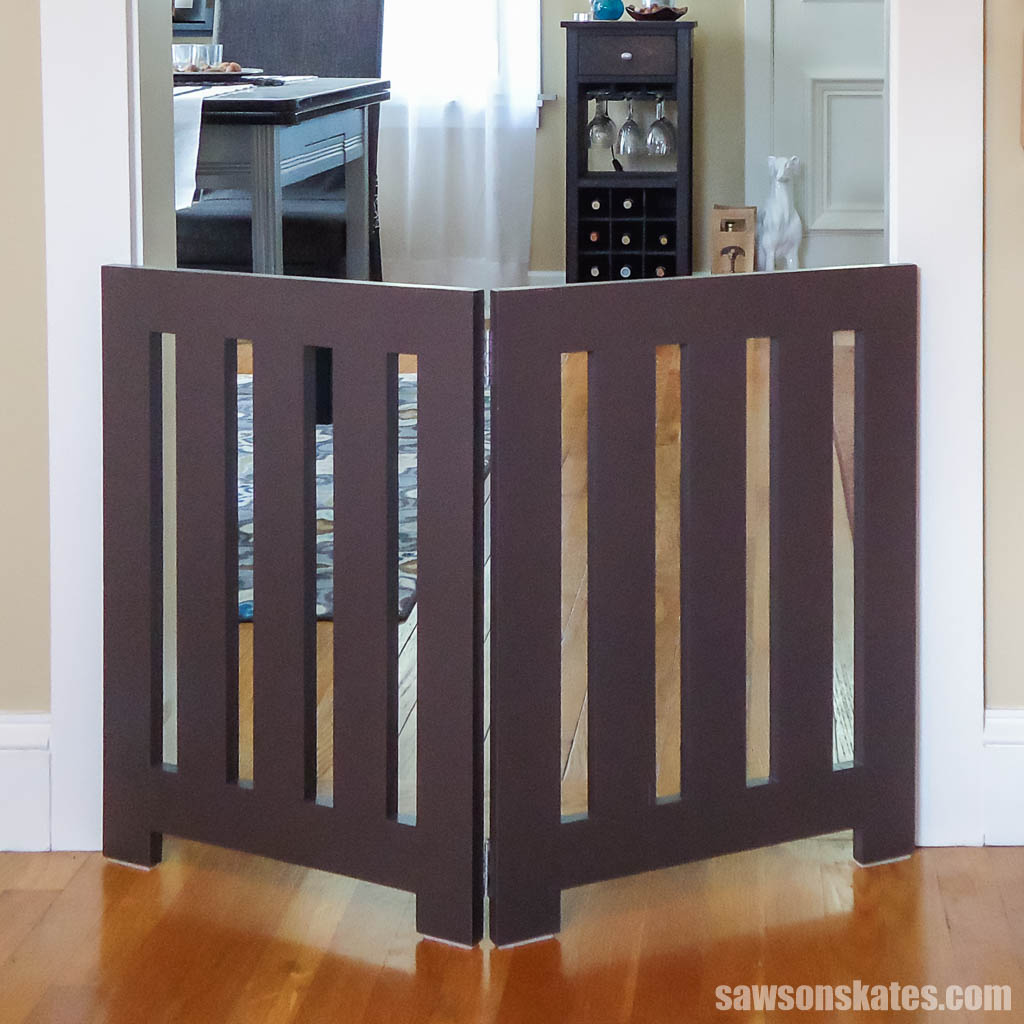 A simple freestanding DIY dog gate in front of a doorway