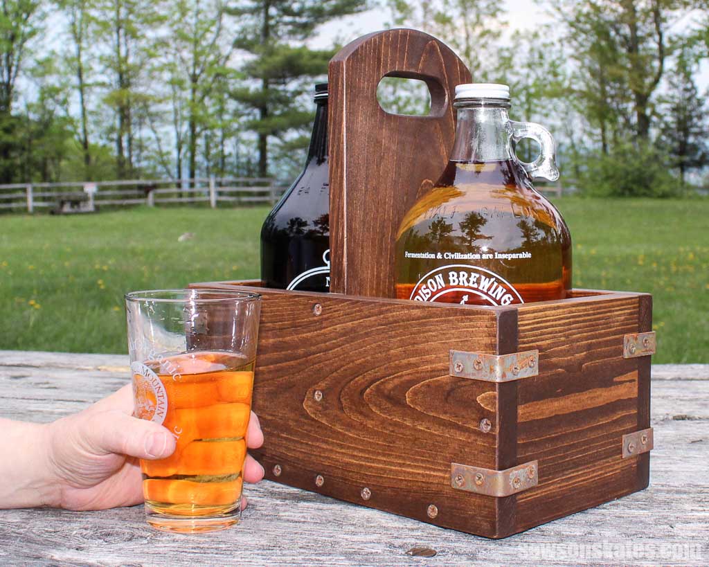 An easy DIY beer growler carrier on a a picnic table