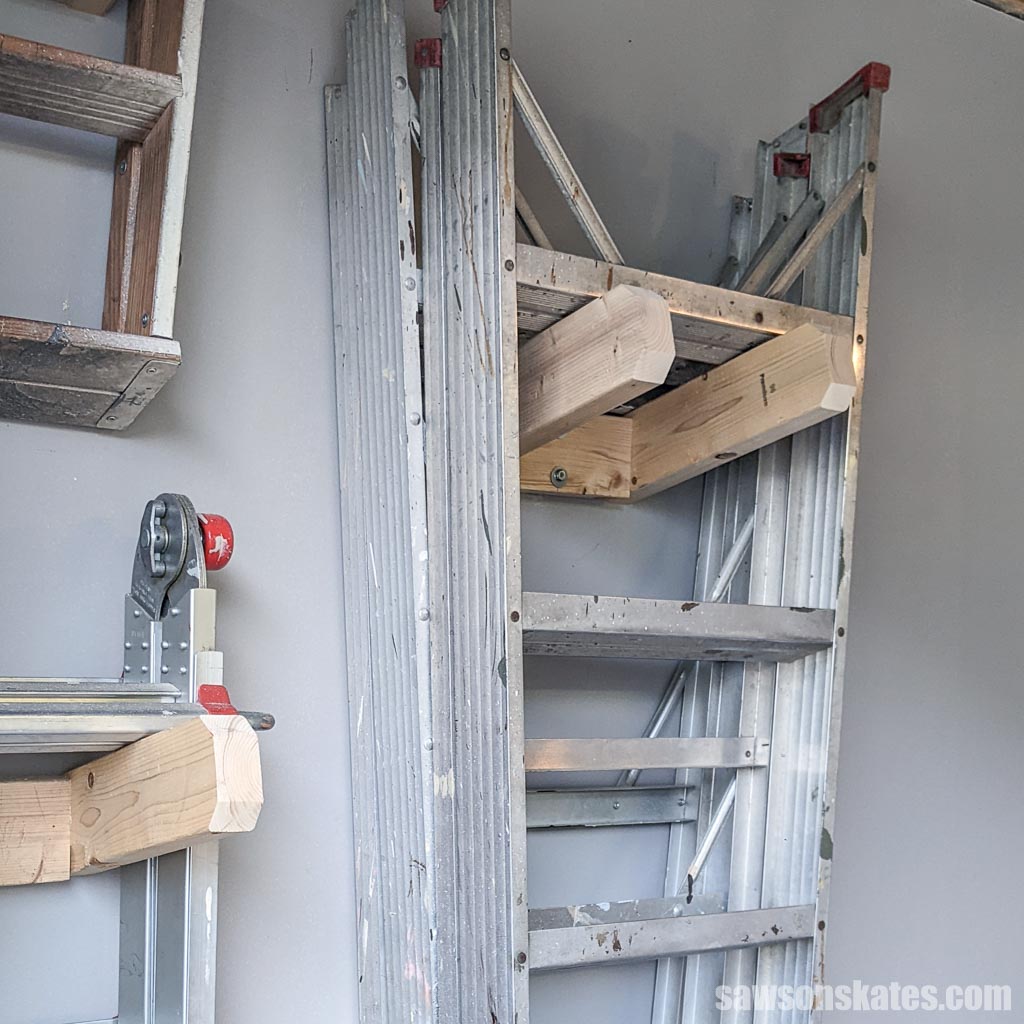 Beginner-friendly ladder holder on the wall with several step ladders