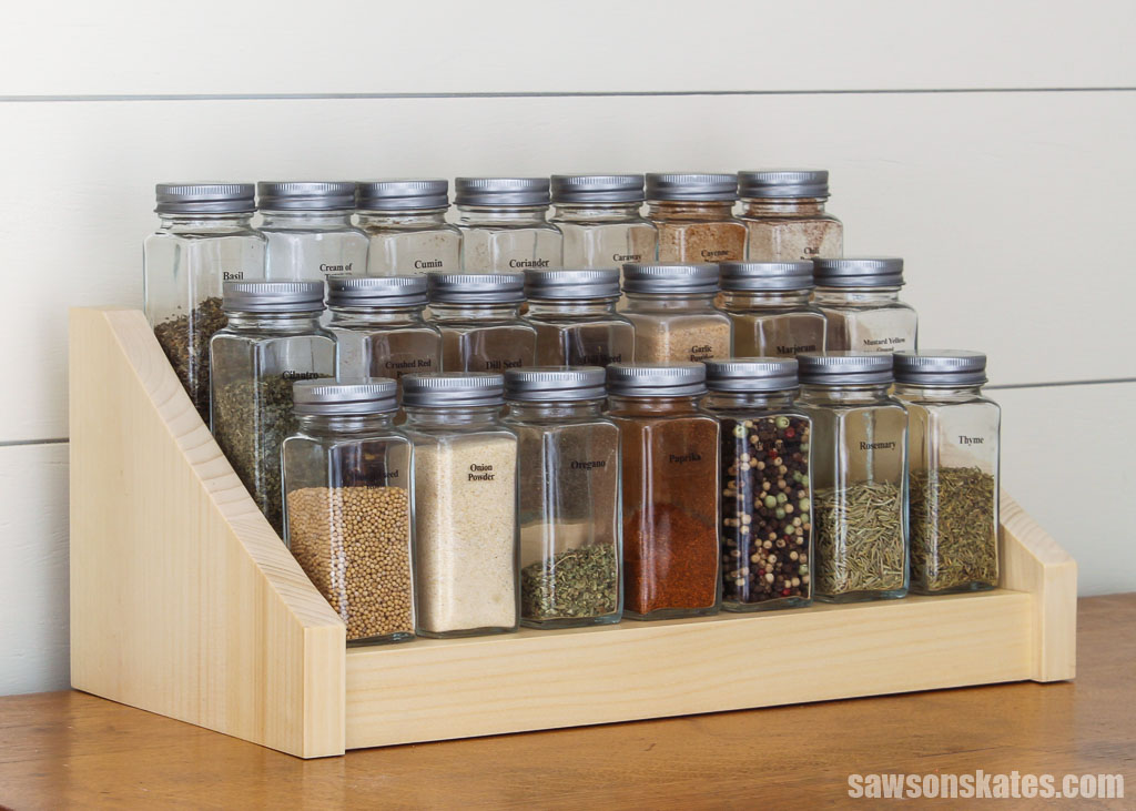 Glass spice jars on a simple-to-make wood DIY tiered spice rack