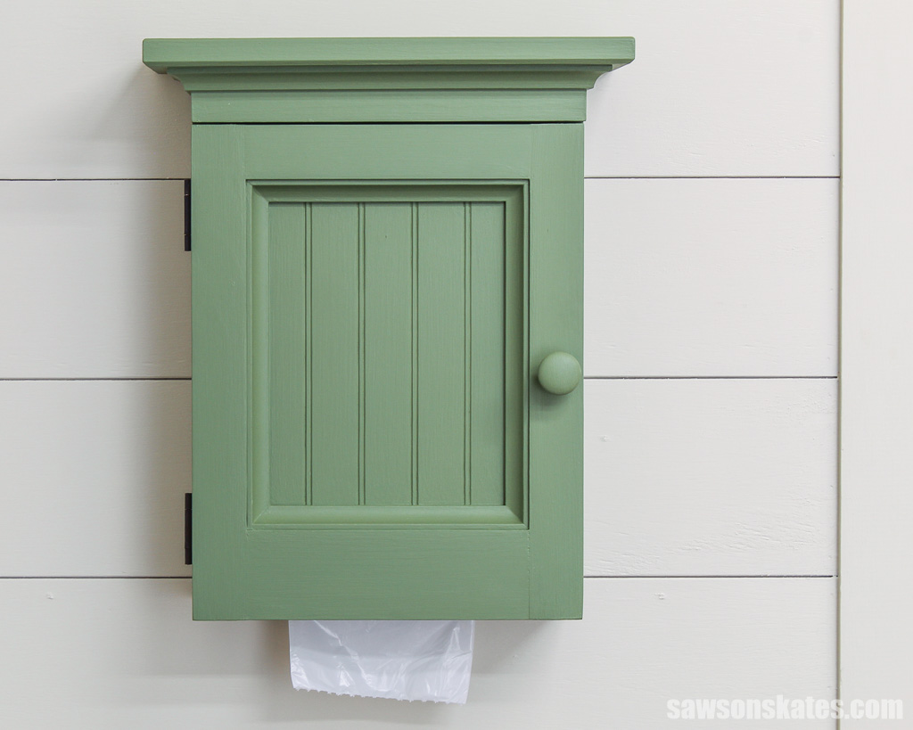 Front view of a DIY wall-mounted trash bag dispenser