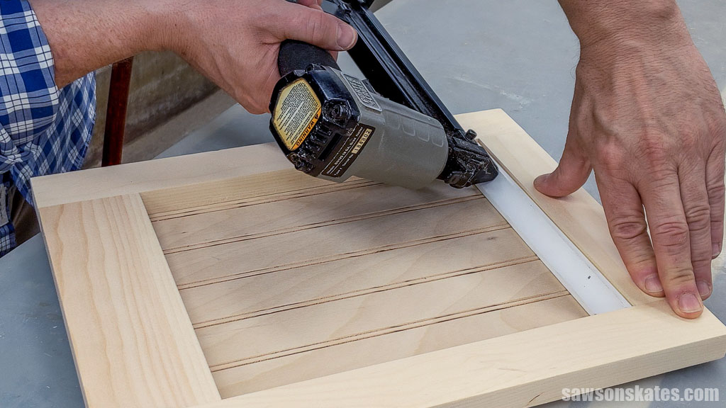 Attaching the door's cove molding with brad nails