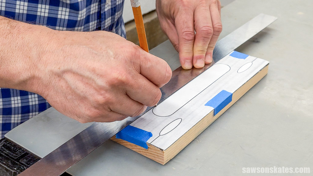 Using a pencil to trace a template for the bottom of a DIY trash bag dispenser