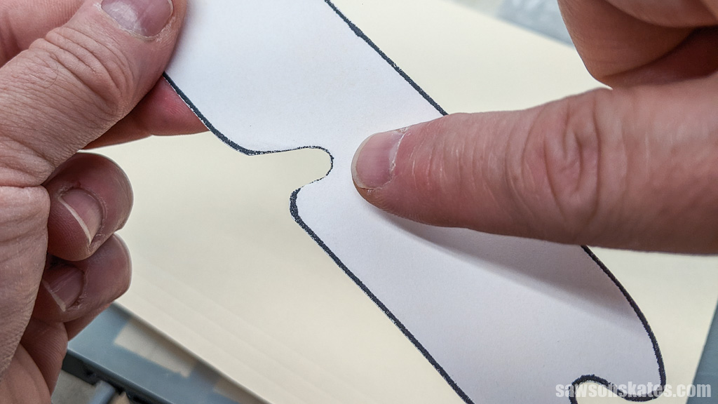 Finger pointing to a paper template