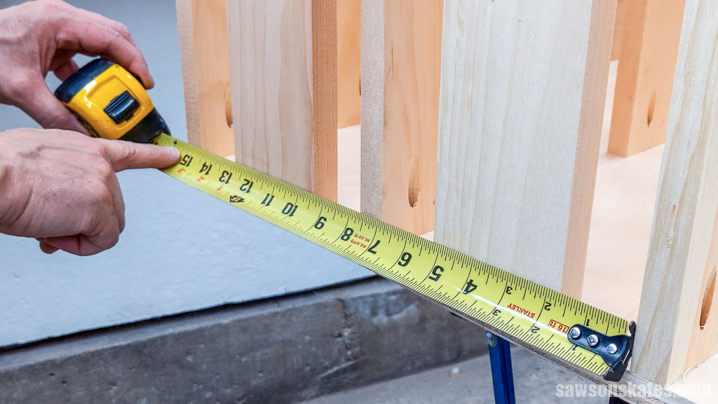 Measuring between a small DIY lumber cart's upper assembly and the front of the cart