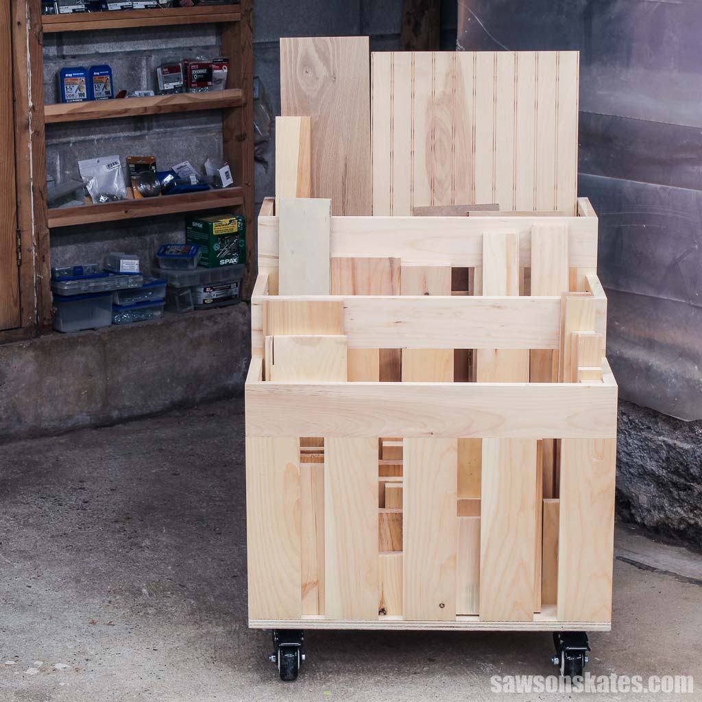Small DIY lumber cart on wheels filled with boards and plywood