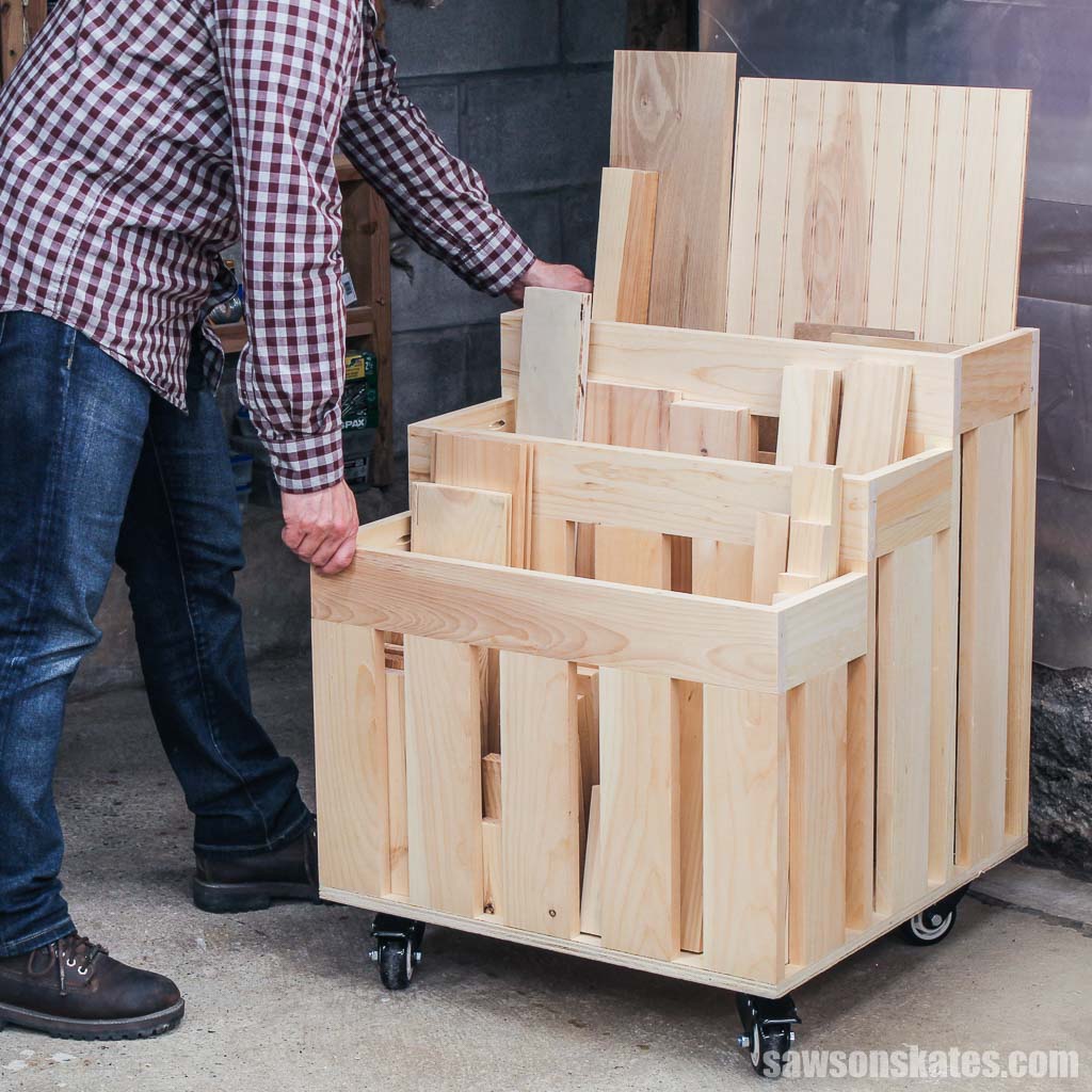 Person rolling a compact DIY lumber cart on wheels