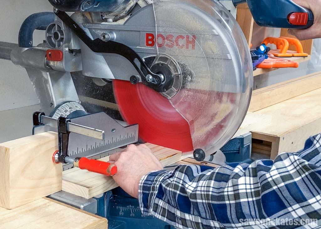 Using a saw to cut a board to its required length