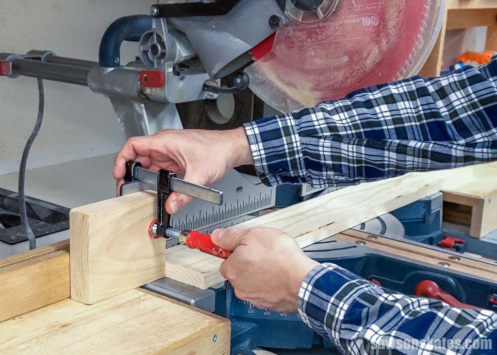 Hands setting a stop on a saw