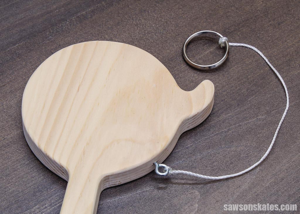 Closeup of a DIY hook-and-ring game's paddle