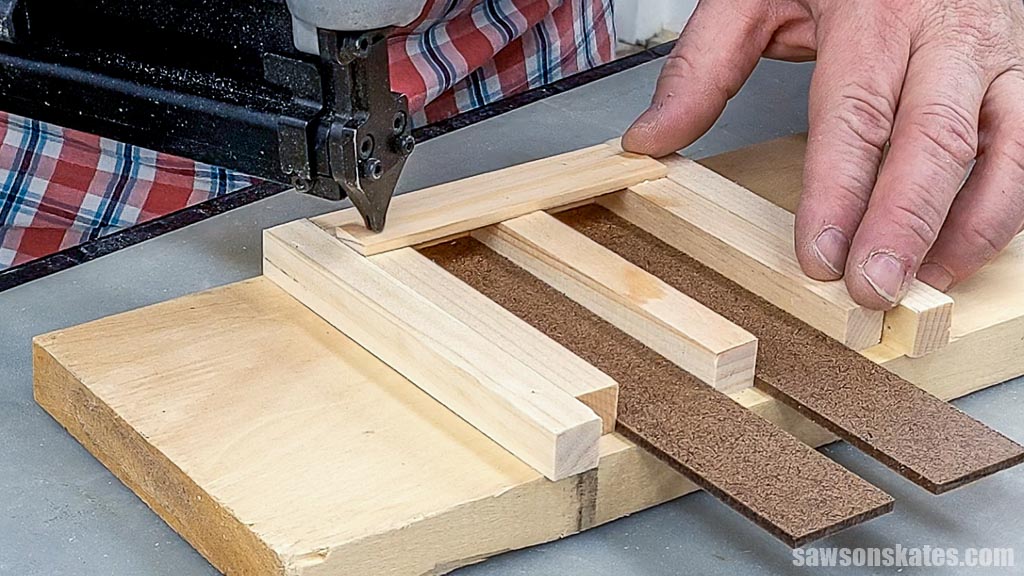 Using a pin nailer to attach a deck board to a stringer for a mini pallet coaster
