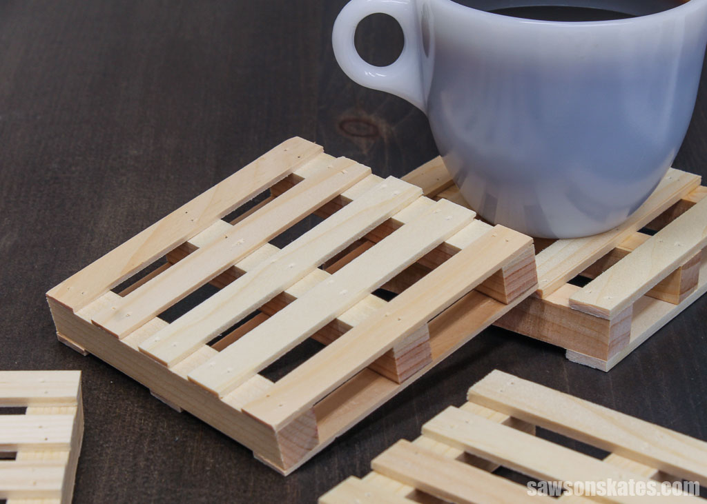 Several miniature DIY pallet coasters on a table