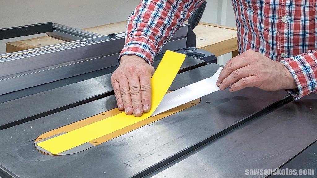 Applying zero clearance tape to a table saw's throat plate