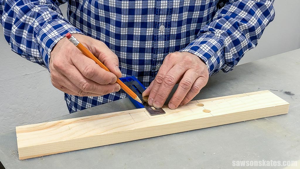 Marking a board for a DIY wooden dowel bow maker's remaining holes
