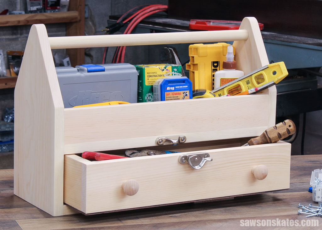 DIY wooden toolbox with a drawer filled with tools on a workbench