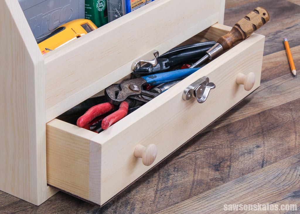 Close up of a DIY toolbox's open drawer with wrenches and a screwdriver
