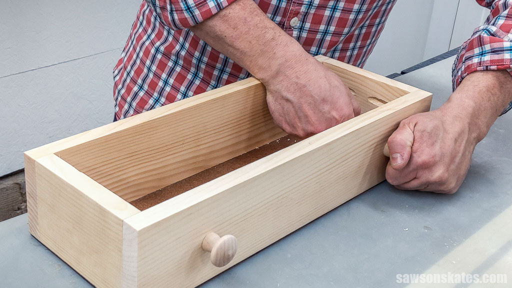 Attaching knobs to a DIY toolbox's drawer