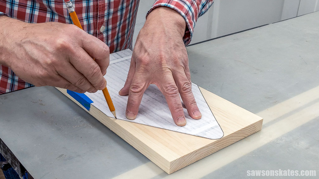 Using scissors to cut out a DIY toolbox's template