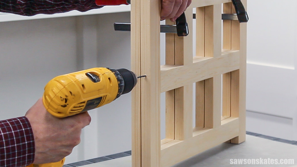Drilling a pilot hole into the side of a DIY countertop wine rack