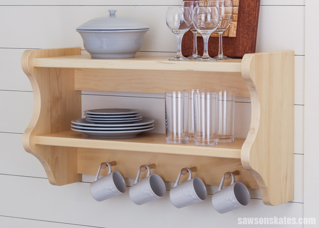 DIY wall-mounted kitchen shelves displayed with plates, glasses and mugs