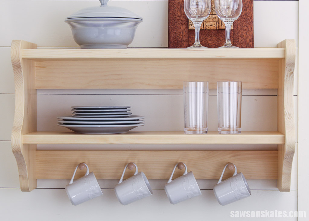 Front view of wall-mounted DIY kitchen shelves hanging on a white wall