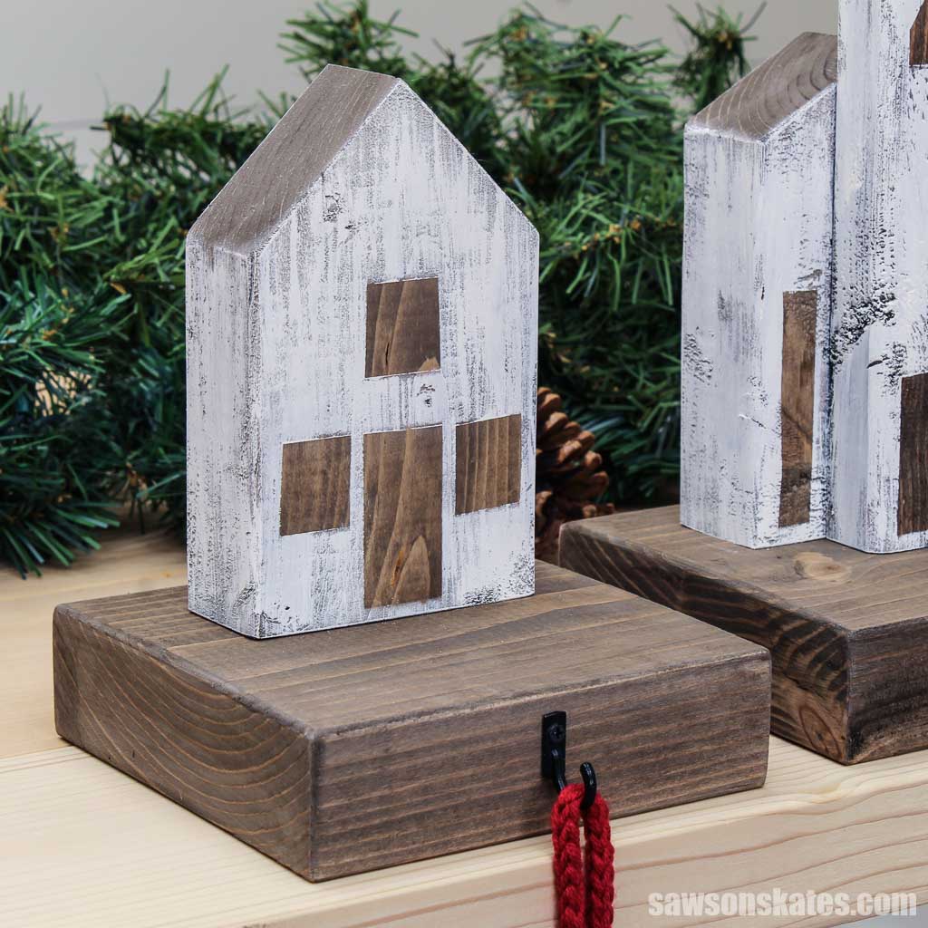 Wood cottage-style DIY Christmas village stocking holder on a table