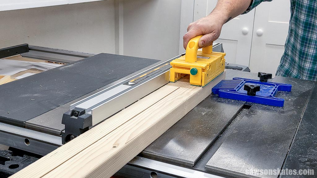 Using a table saw to rip a 2×4 for a DIY bedside table's legs