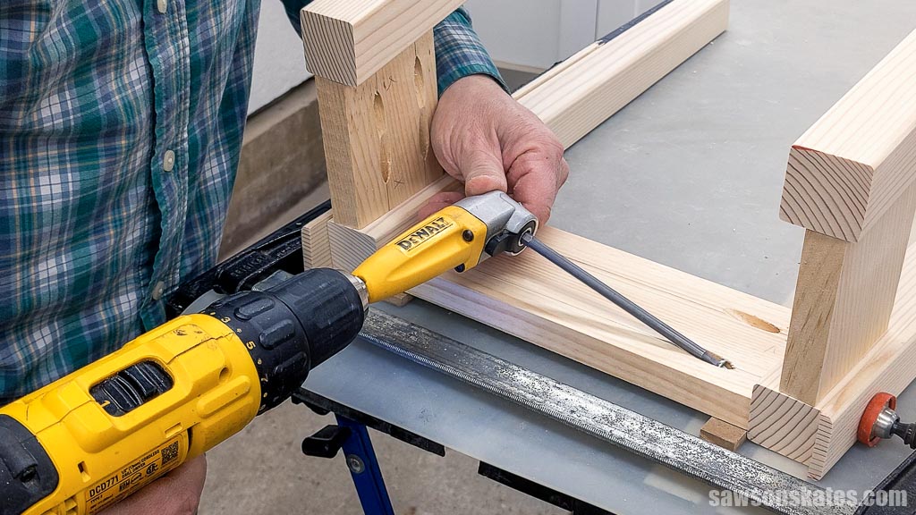Using a right angle drill attachment to join a DIY bedside table's long apron to its legs