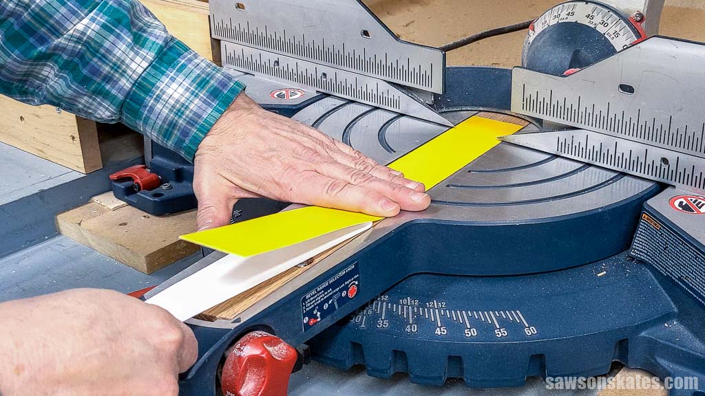 Applying zero clearance tape to a miter saw's throat plate