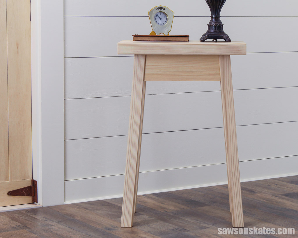 Front view of a rustic style DIY bedside table with splayed legs