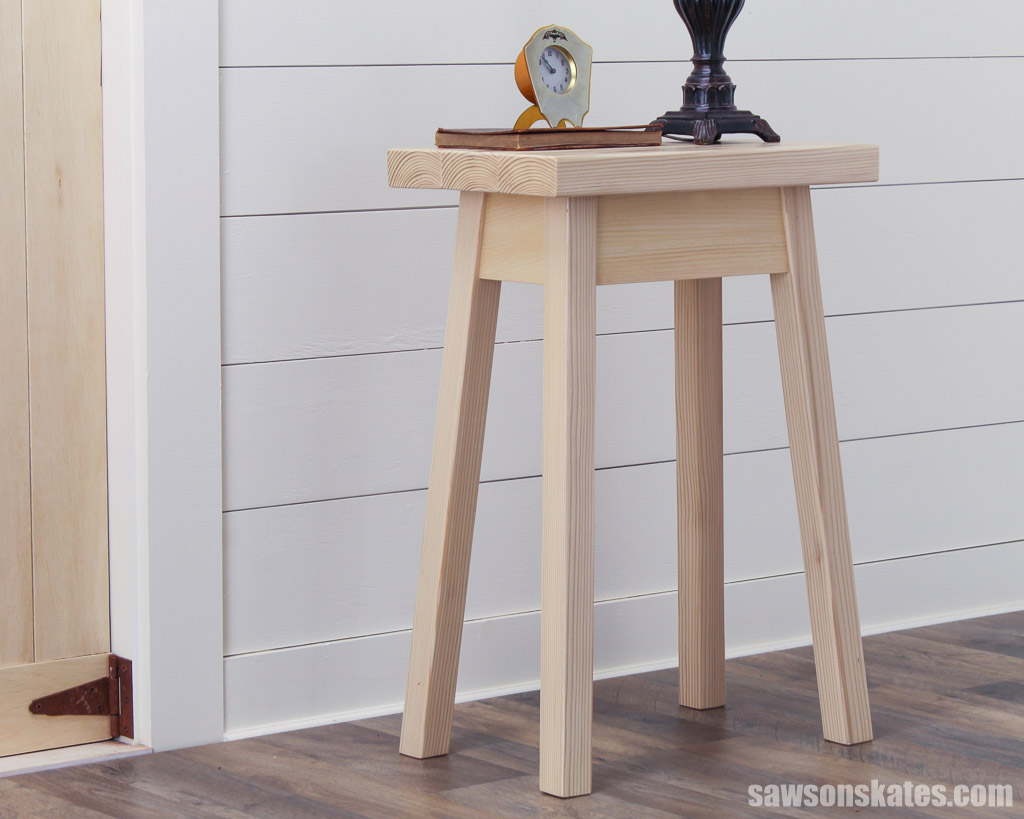 Side view of an easy-to-make DIY bedside table in front of a shiplap wall