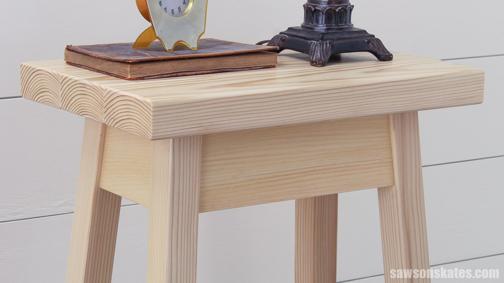 Close up of a simple DIY bedside table's top made with affordable 2×4s