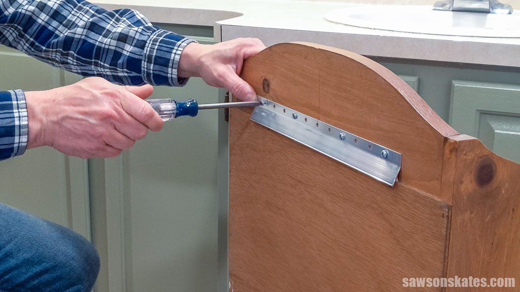 Attaching a bracket to the back of a cabinet