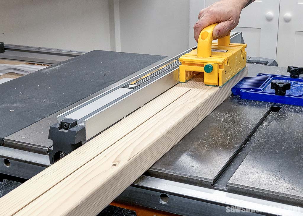 Using a table saw to cut a 2x4 lengthwise