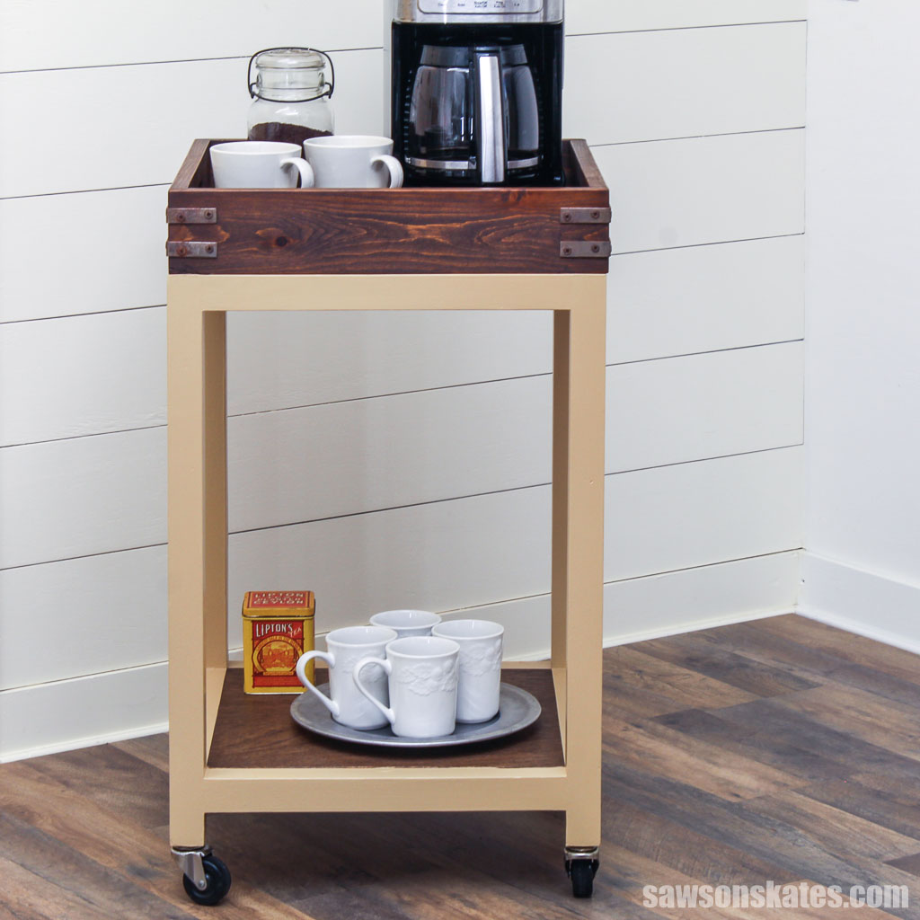 Front view of a diy coffee cart and serving tray including a coffee maker and white mugs