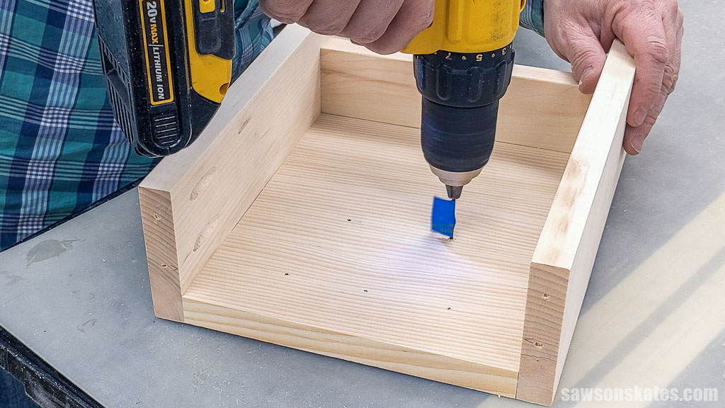 Using a drill to make pilot holes for key hooks